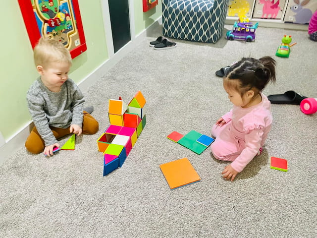 a couple of children playing with toys