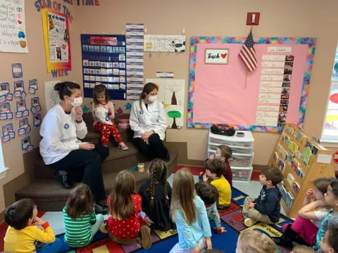 a group of people sitting in a classroom