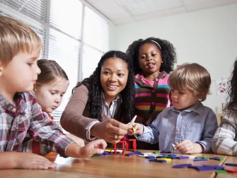 a person and several children sitting at a table