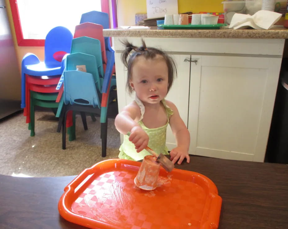 a little girl eating a cake