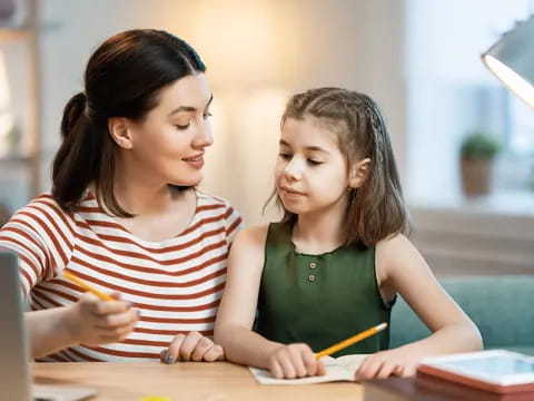 a woman and a girl studying