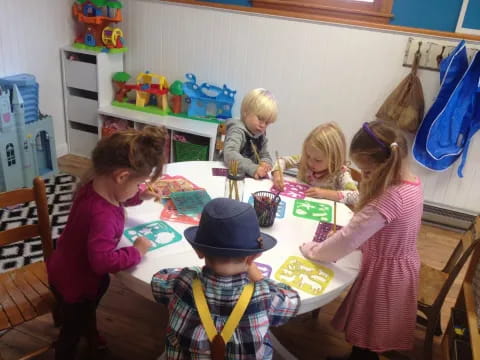 a group of children sitting around a table