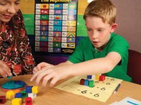 a boy and a girl playing a board game