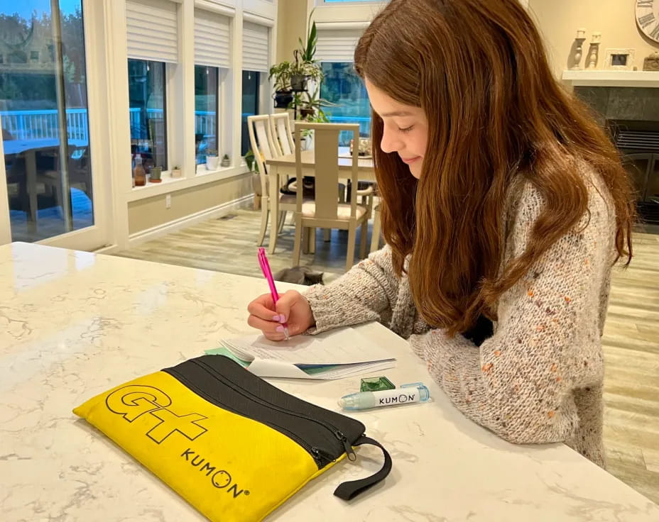 a woman writing on a book