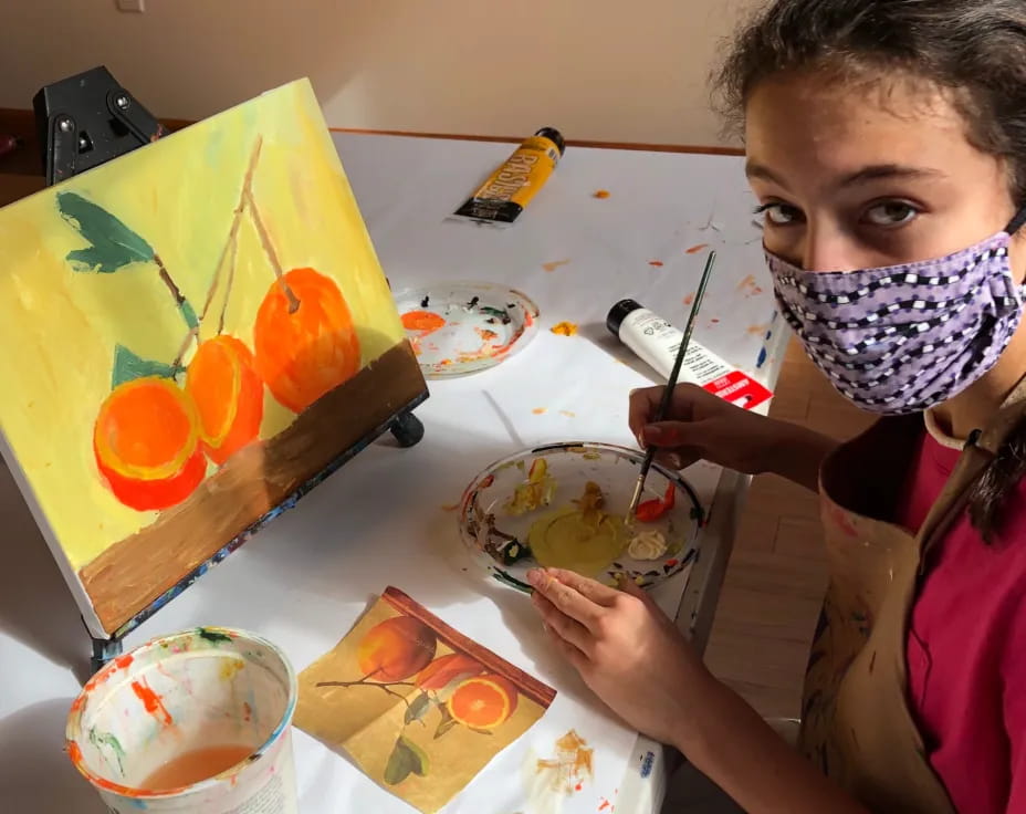 a girl painting on a table