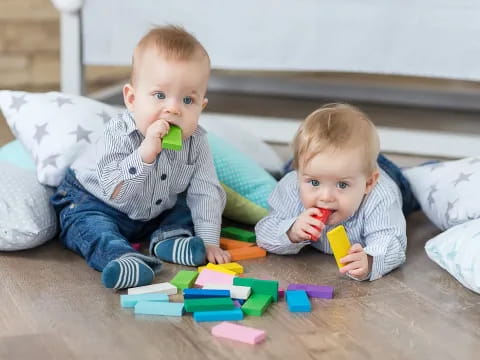 two babies sitting on the floor