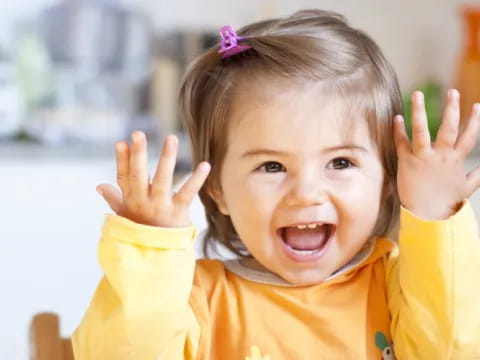 a child with her hands up