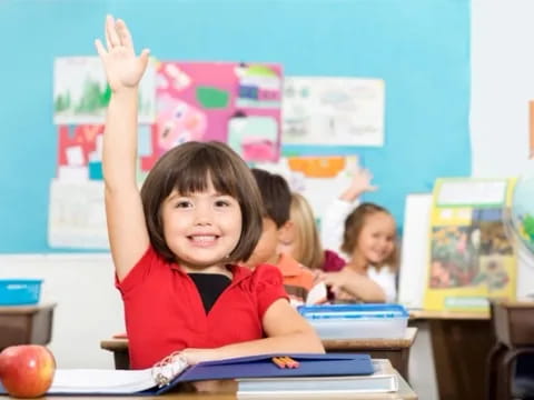 a young girl raising her hands