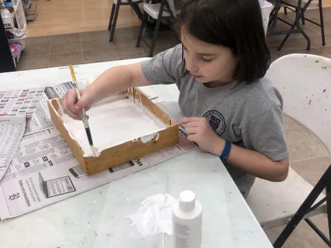 a person painting on a table