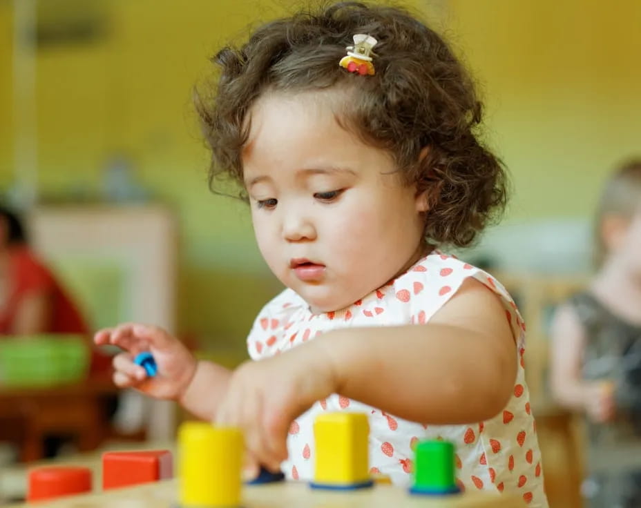 a young girl playing with toys