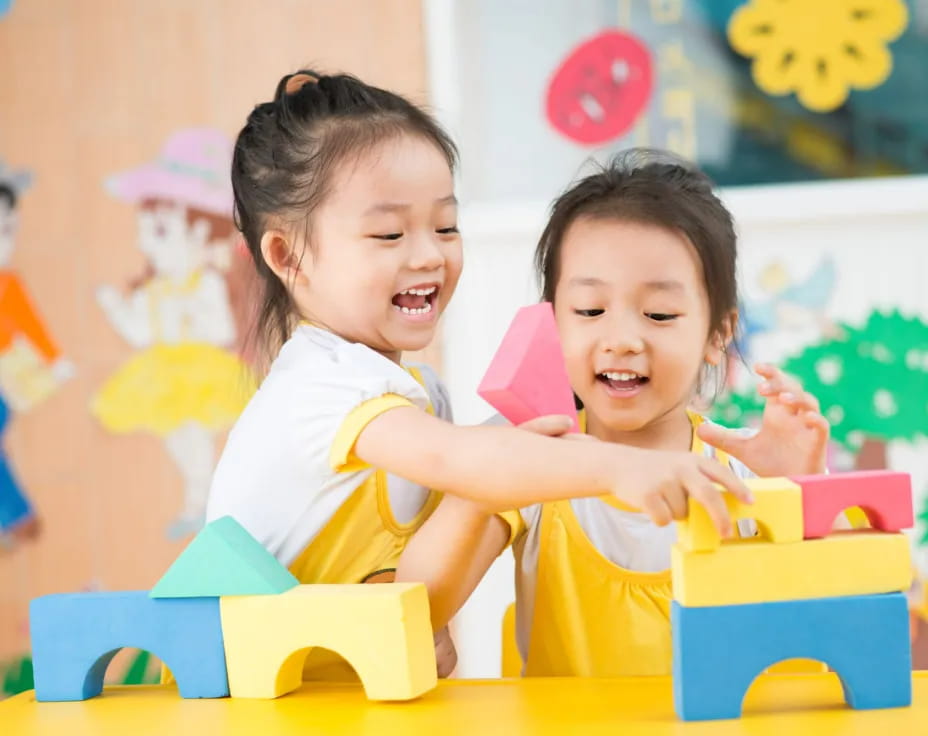 a couple of young girls playing with toys