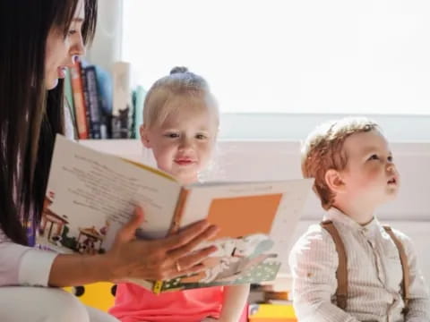 a person reading a book to a child