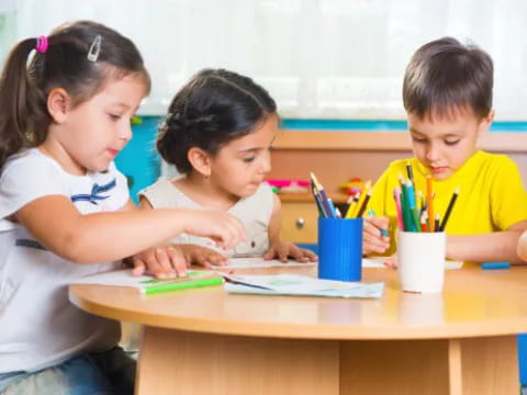 a few children sitting at a table