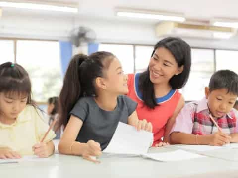 a person and several children looking at a paper