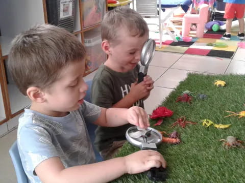 two boys sitting on the floor