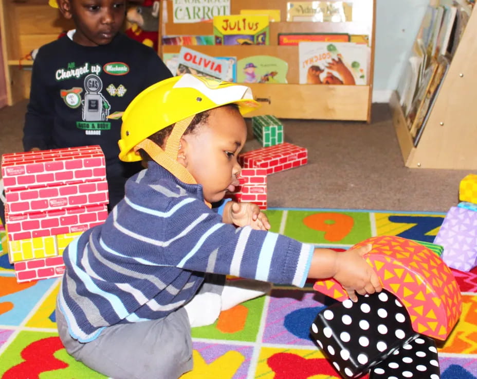 a couple of kids wearing hard hats