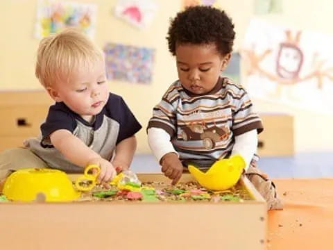 two boys playing with toys