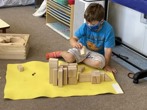 a child sitting on a yellow block