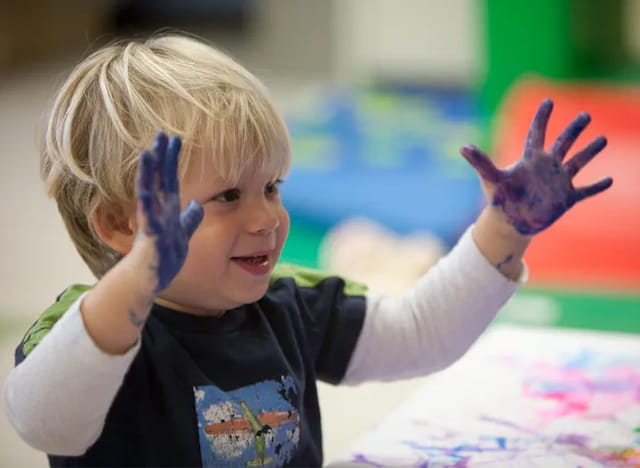 a child with their hands up