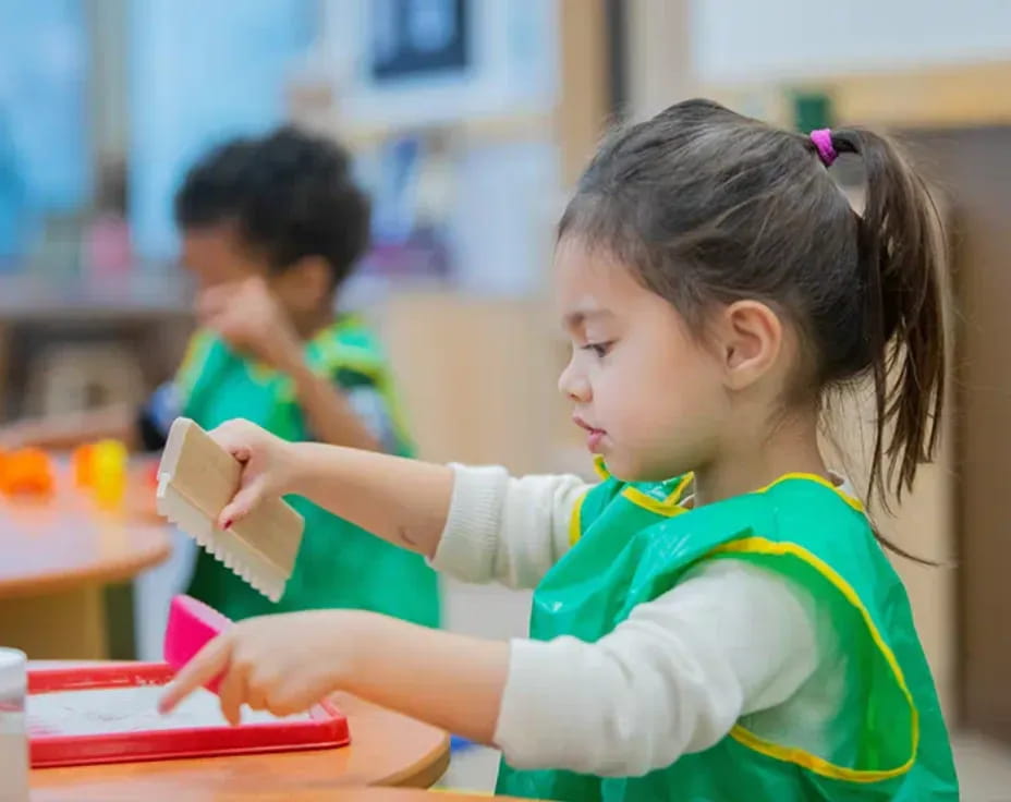 a young girl writing on a book