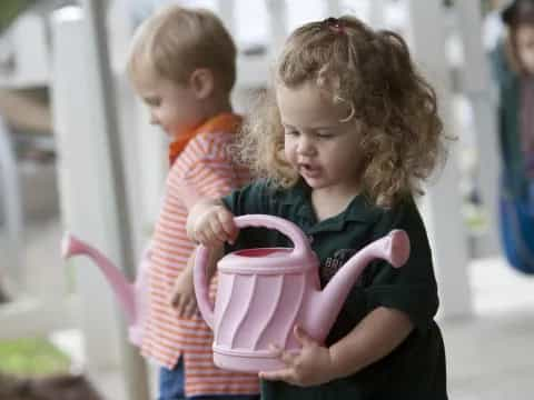 a couple of children playing with a toy