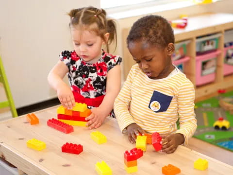 a couple of children playing with toys