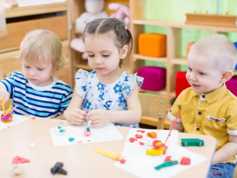 a group of children sitting at a table