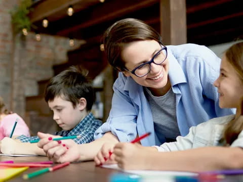 a person and children sitting at a table