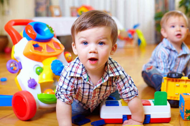 a couple of young boys playing with toys