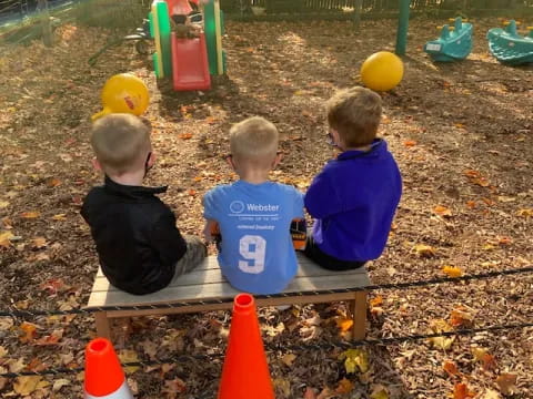 a group of boys sitting at a picnic table