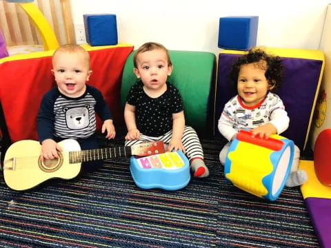 a group of kids sitting on a couch with toys