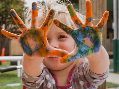 a child with a colorful mask