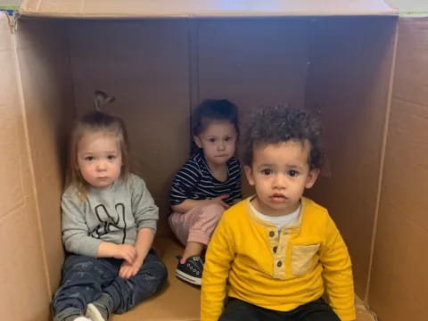 a group of children sitting in a box