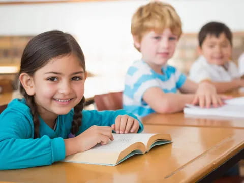 a few children sitting at a table