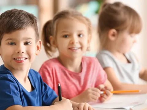 a few children sitting at a table