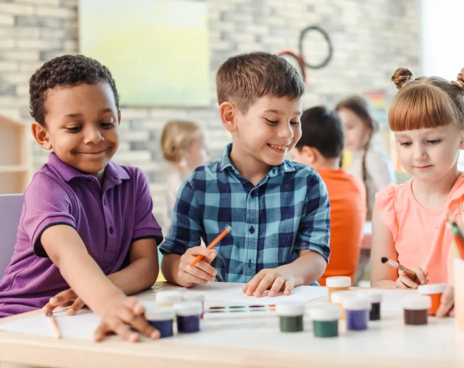 a group of children sitting at a table