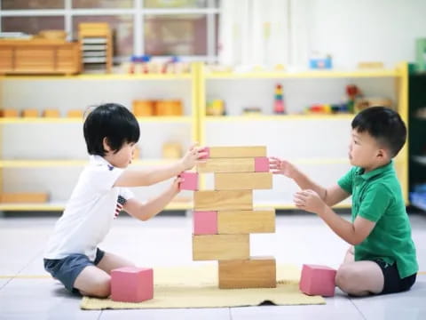 a couple of kids playing with blocks