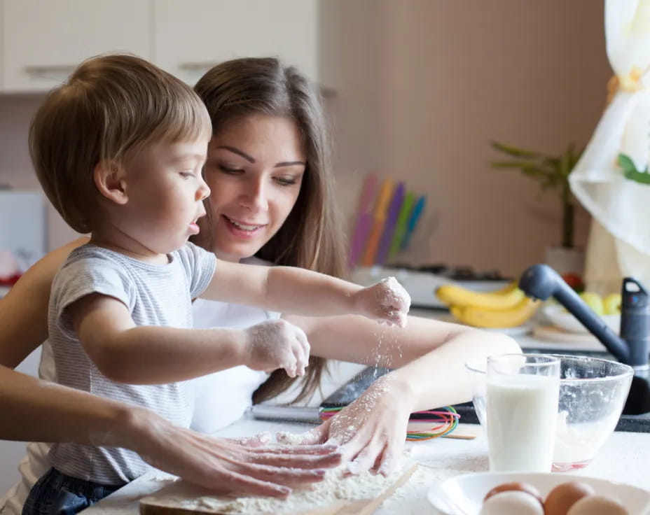 a woman and a child playing with sand