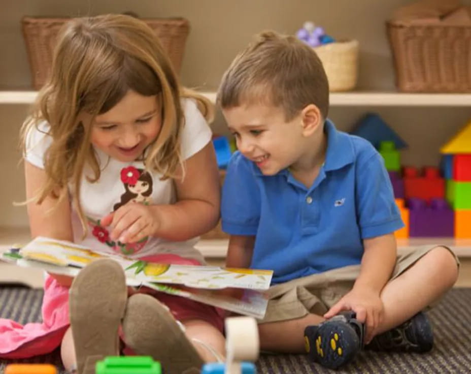 a boy and girl playing with toys