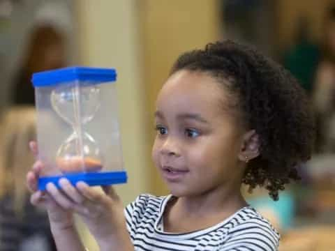 a young girl holding a plastic cup