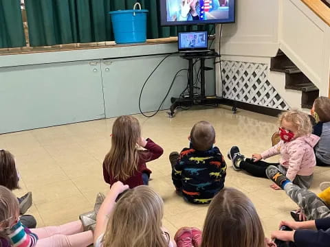 a group of children watching a television
