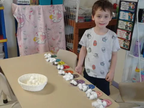 a child standing next to a table