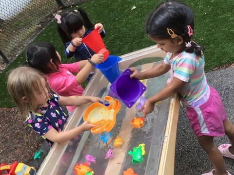 a group of children playing in a play area