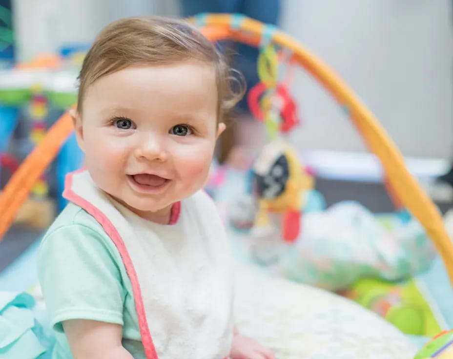 a baby sitting on a bed