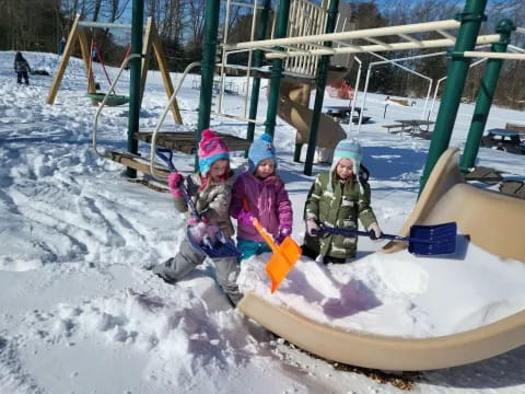 a group of kids playing in a snowman
