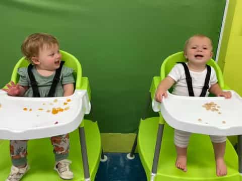 a couple of kids sitting in chairs