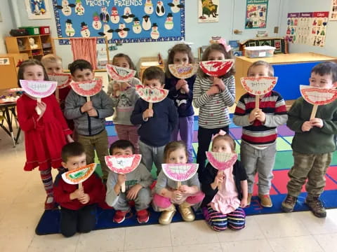 a group of children holding stuffed animals