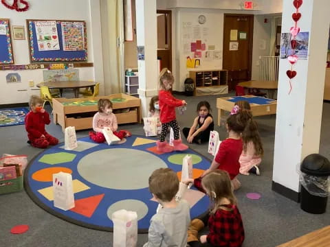 a group of children playing on a mat in a room