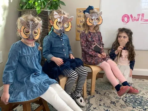 a group of people sitting on stools wearing clothing