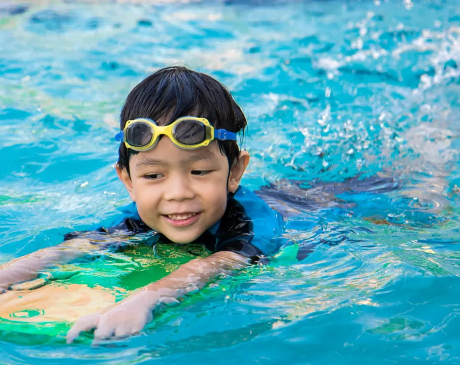 a boy wearing goggles in a pool